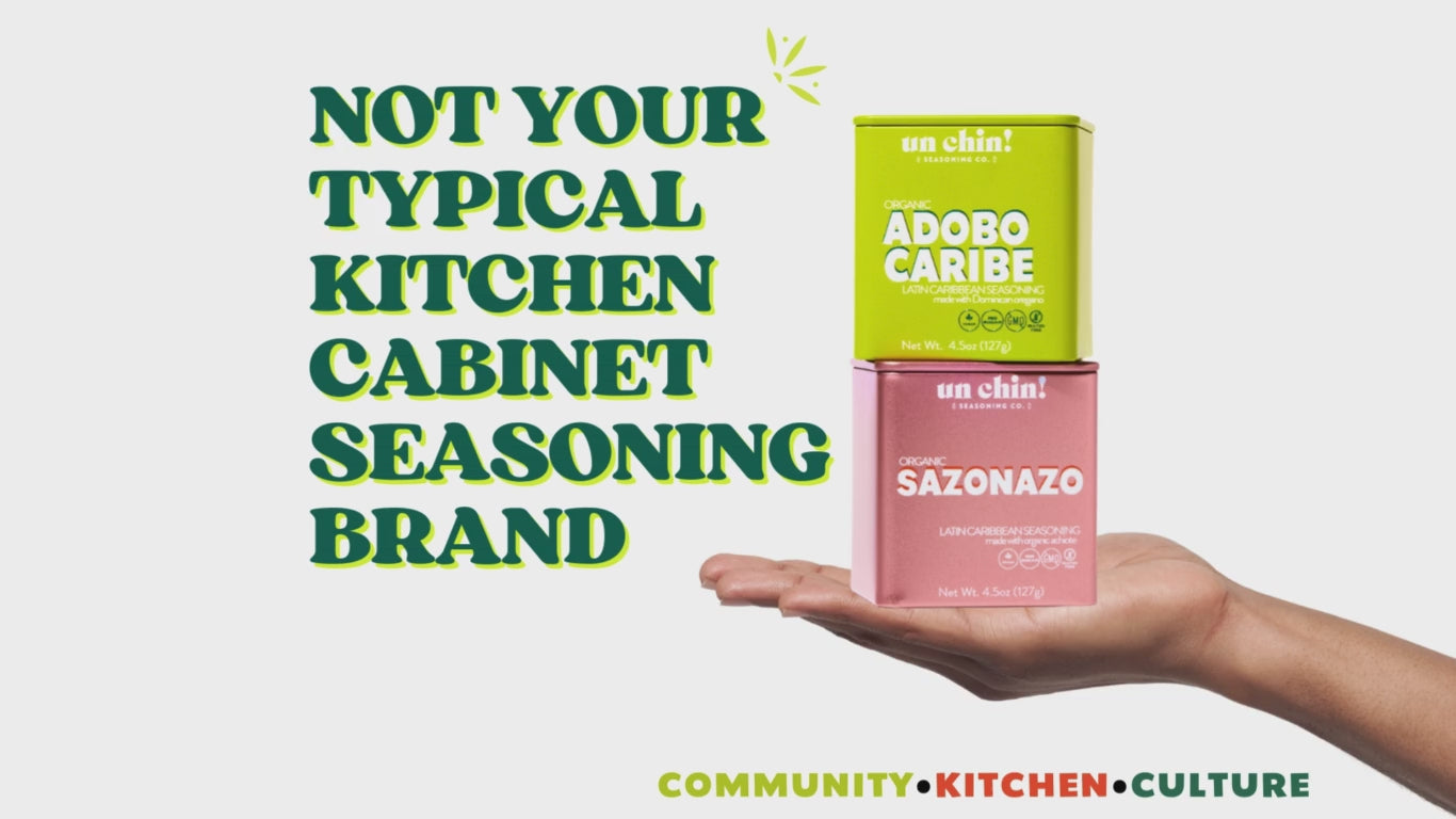 Load video: Image of two seasonings in hands on white background with text that reads not your typical kitchen cabinet seasoning brand and community kitchen and culture.